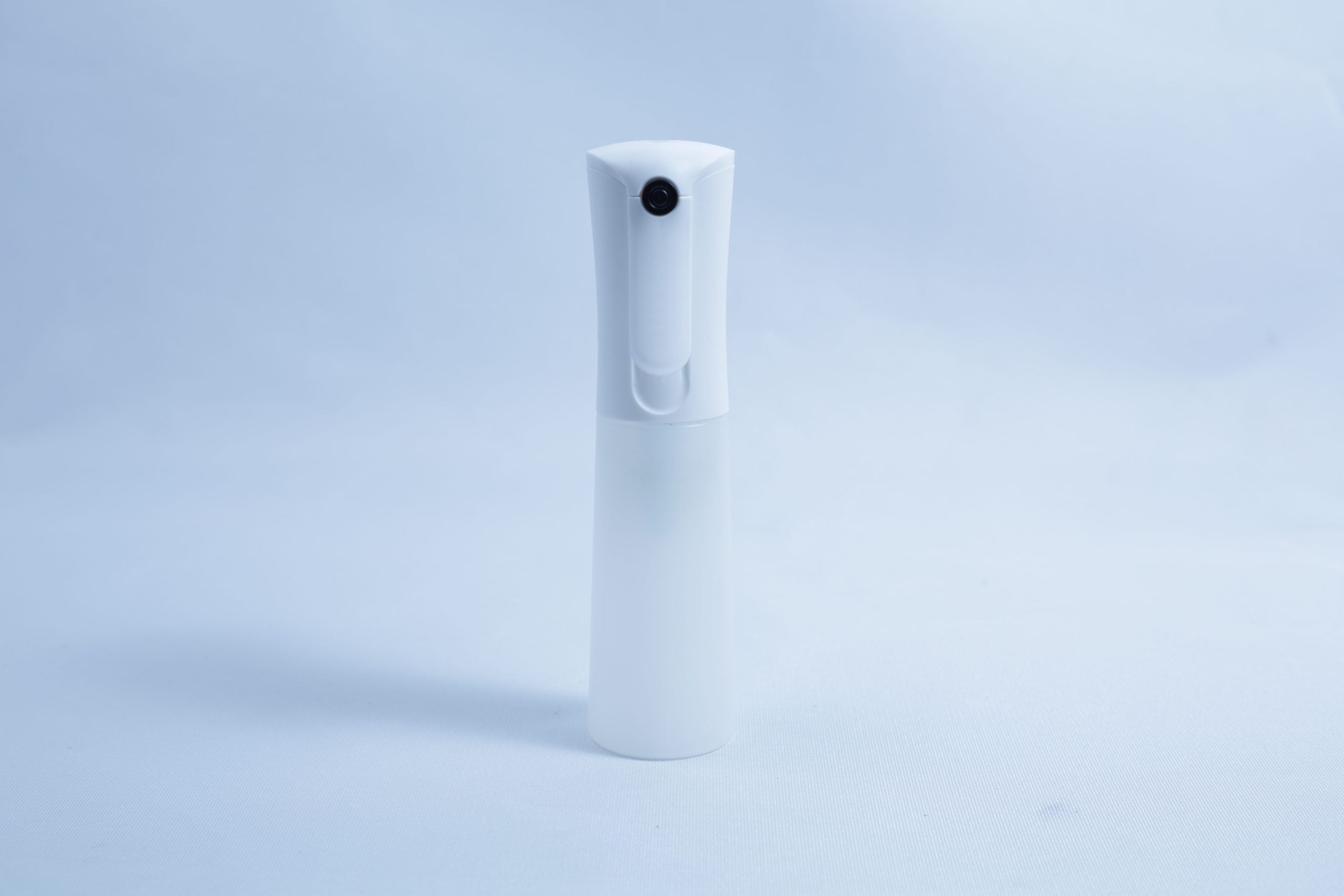 Monotub Mushroom Growing Kit-Premium 3 A white plastic spray bottle, ideal for use with the Monotub Mushroom Growing Kit-Premium, stands upright on a plain light blue background.