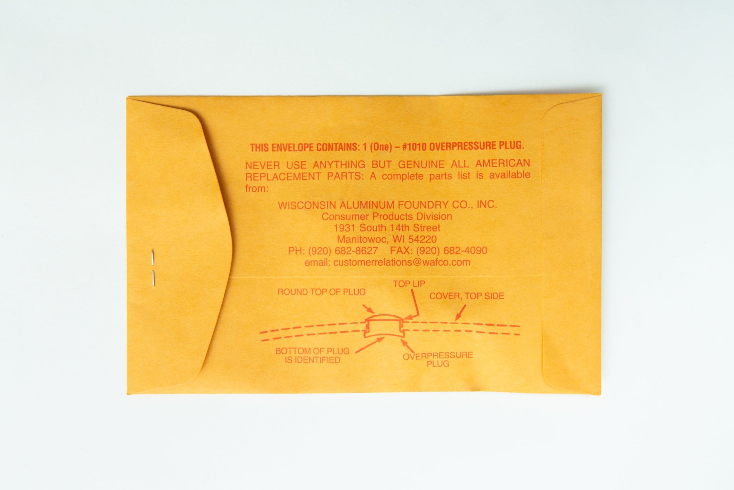 All American rubber overpressure plug for sterilizer | Orange | Part 1010 2 The All-American rubber overpressure plug for steriliser (Orange, Part 1010) is shown on a white background in a brown envelope with red printed instructions, sealed by a metal clasp.
