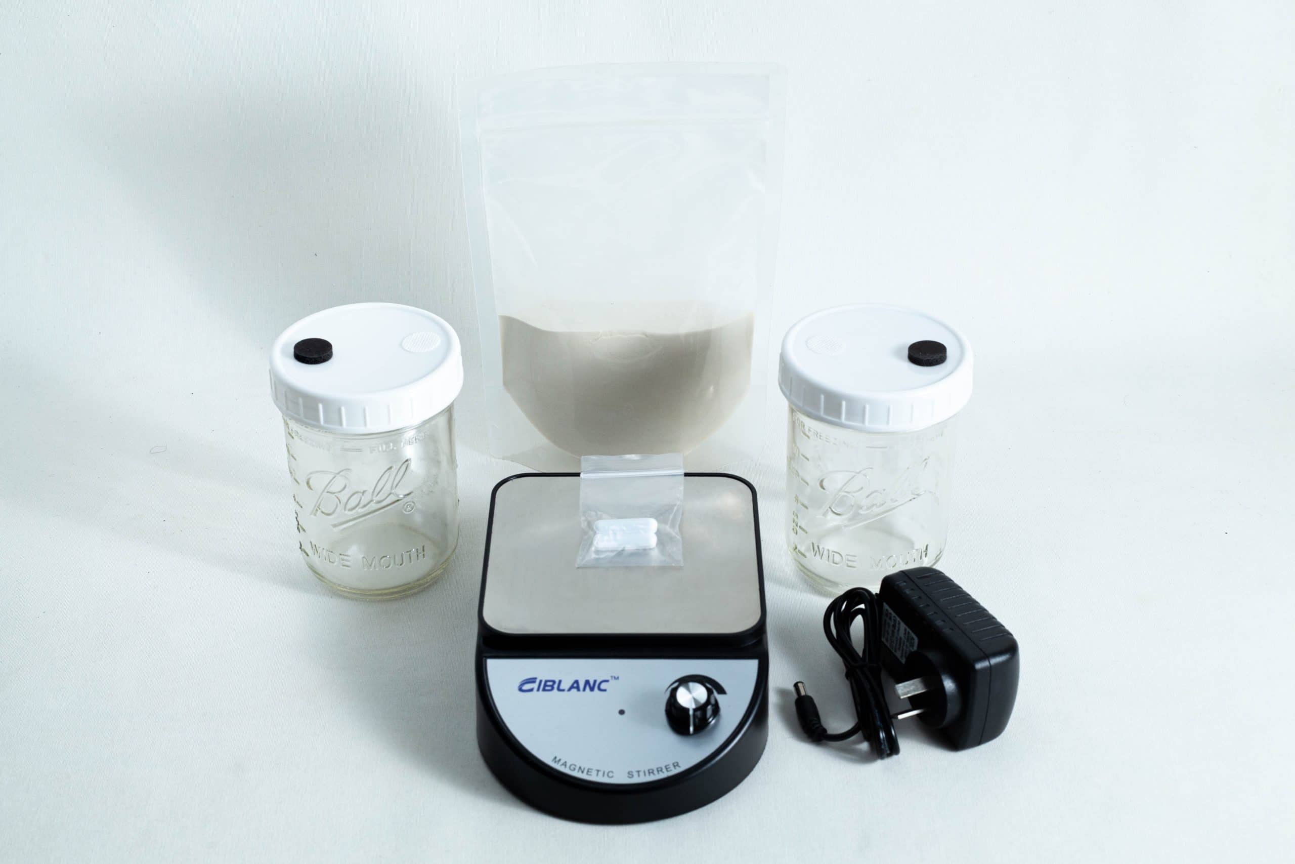 Liquid Culture Kit with Jar, Magnetic Stirrer and LC Mix 1 The Liquid Culture Kit with Jar, Magnetic Stirrer and LC Mix includes two jars, a clear pouch of LC mix powder, a magnetic stirrer, and a power adaptor—all shown on a white background.