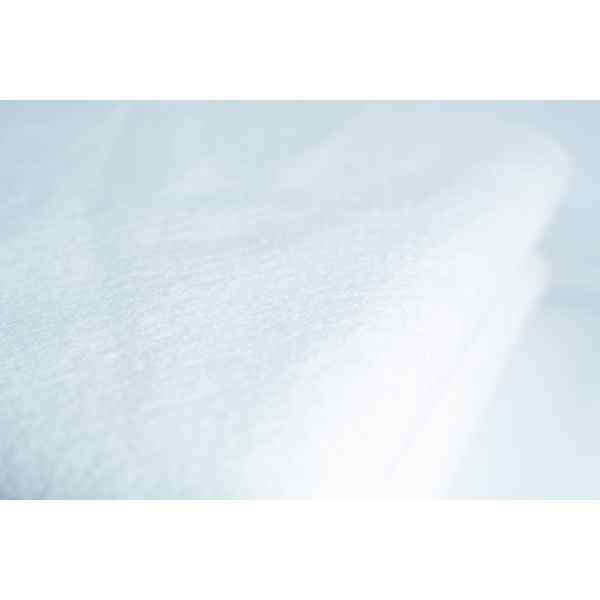 Close-up of the Light Log Blanket, showcasing its soft, textured white fabric.