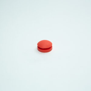 A single round orange pill, resembling an All American rubber overpressure plug for steriliser (Part 1010), is centred on a plain white background.