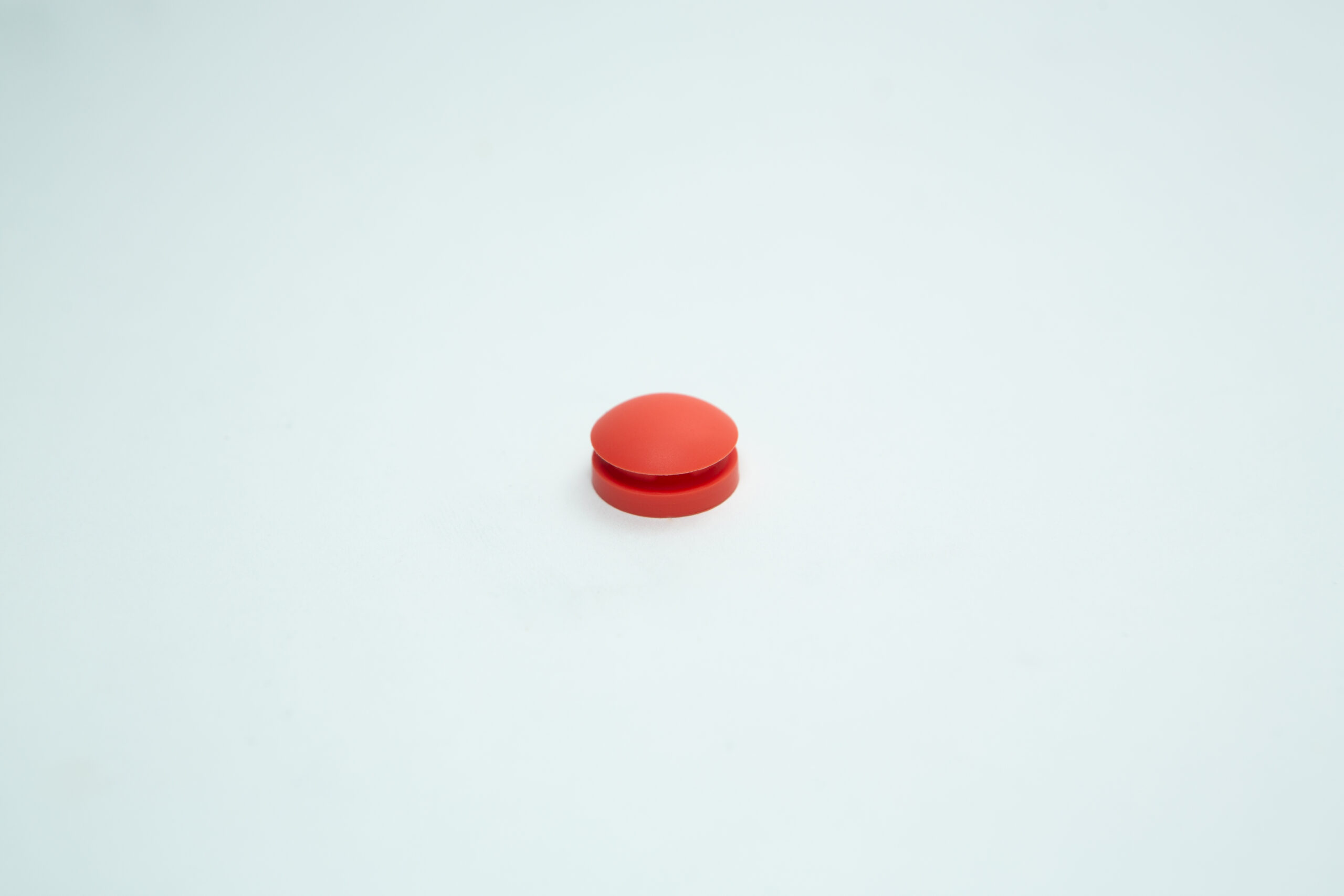 All American rubber overpressure plug for sterilizer | Orange | Part 1010 1 A single round orange pill, resembling an All American rubber overpressure plug for steriliser (Part 1010), is centred on a plain white background.