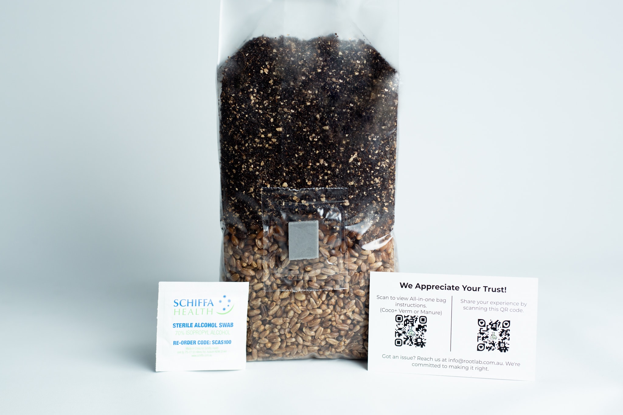 All in one Coco Coir+Vermiculite | organic rye | Millet | 1kg | 2kg Mushroom bag | Instruction 3 A sealed bag of seeds and soil with two informational cards displayed in front of it on a white surface.