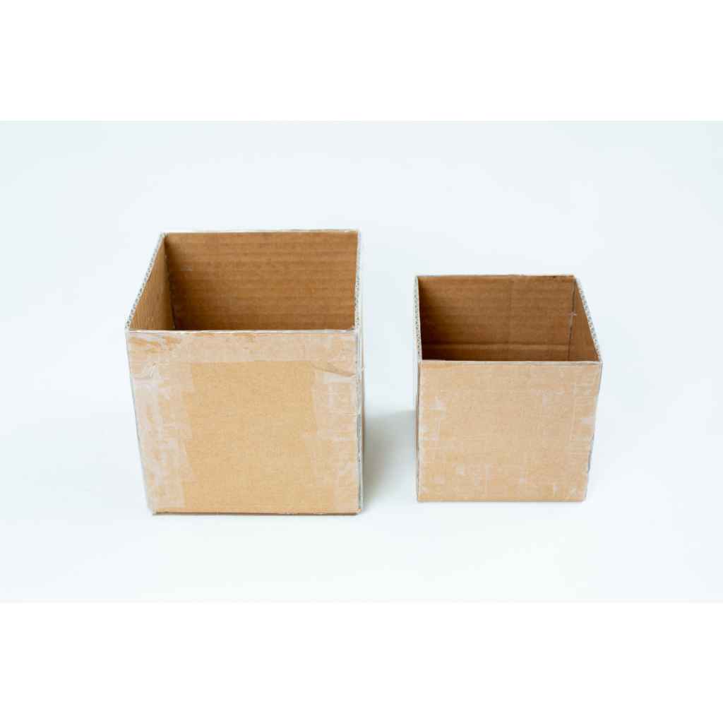 Making Growth Forms for Mycelium based Composites 3 Two empty cardboard boxes, one larger and one smaller, placed side by side on a white background.