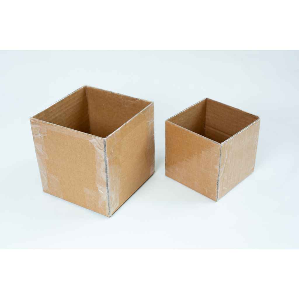 Making Growth Forms for Mycelium based Composites 2 Two empty cardboard boxes of different sizes on a white background.