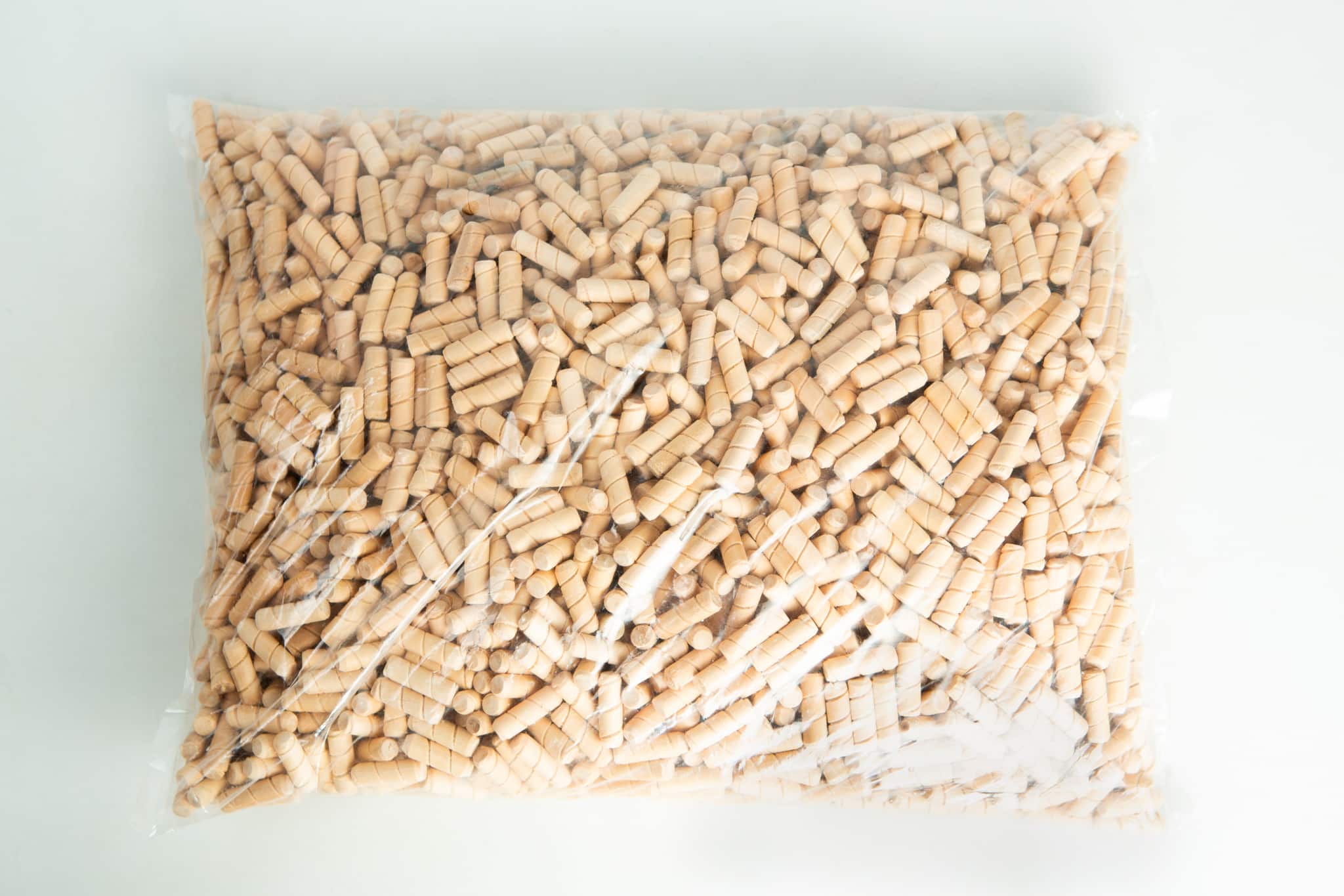 Uninoculated Birch Hardwood dowel plugs for mushroom logs 1 A clear plastic bag filled with small, cylindrical wooden pegs on a white surface.