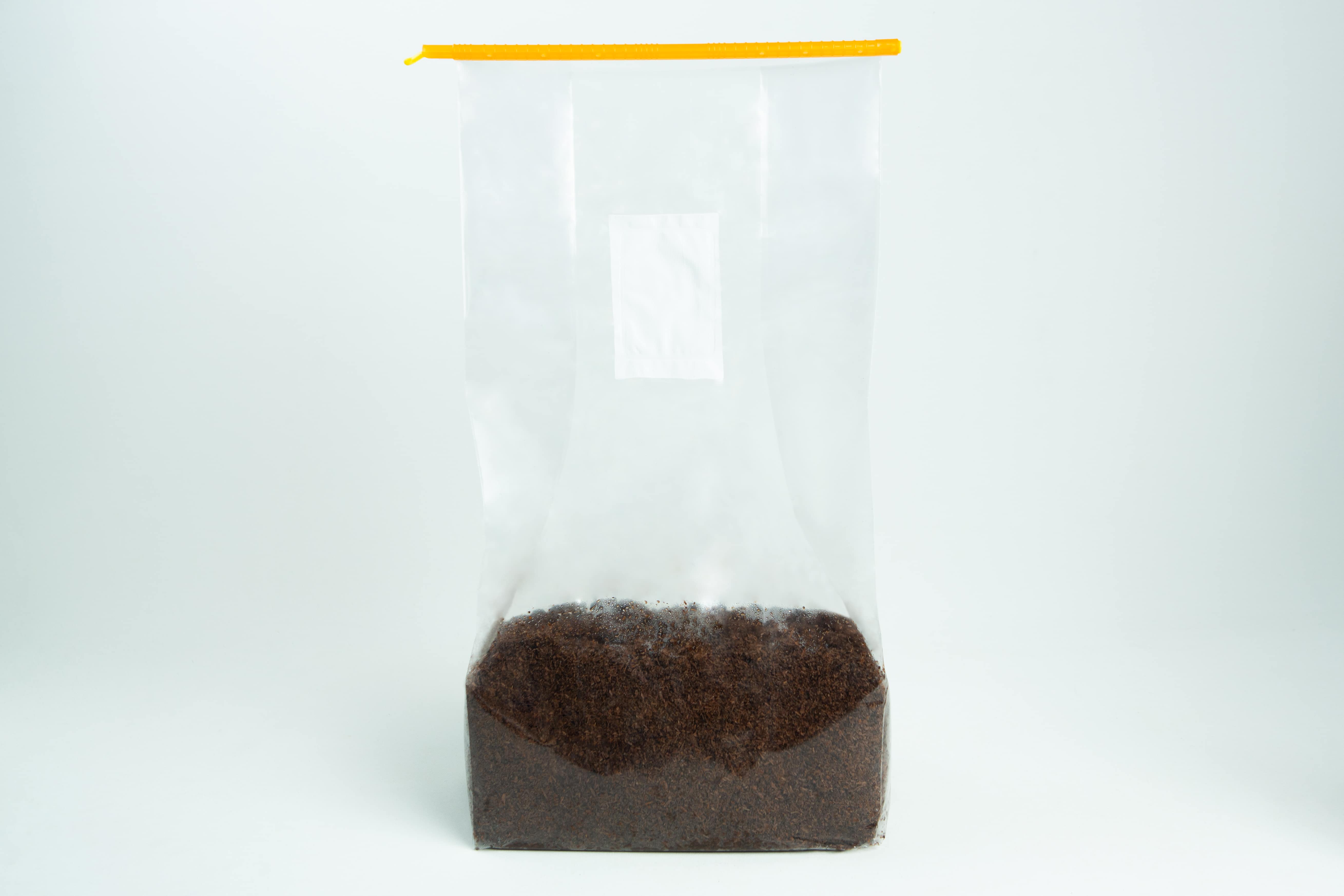 Mushroom bag sealing clip | Reusable 5 Clear plastic bag with a yellow zip, partially filled with loose black tea leaves.