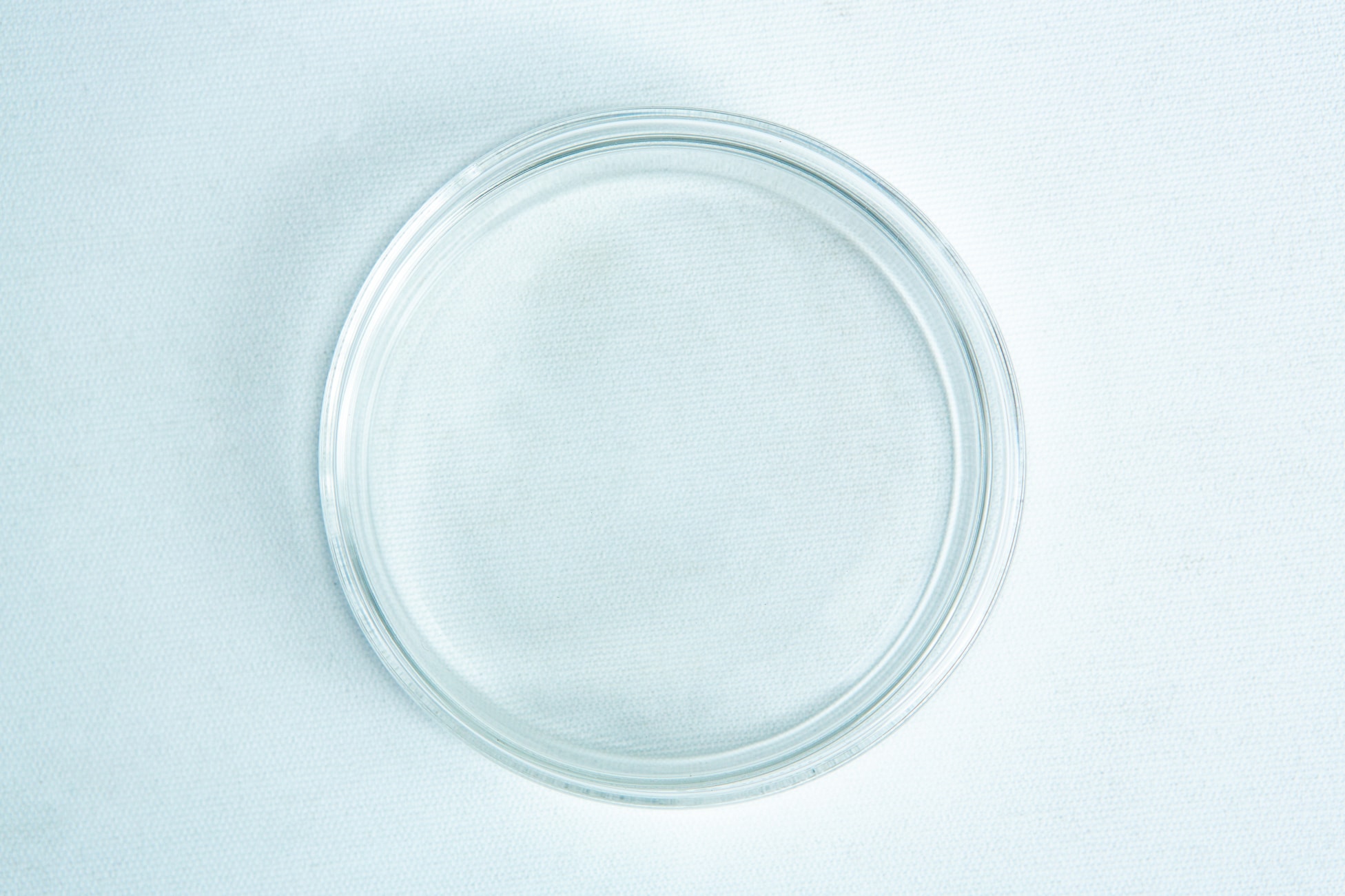 Brosciliate Glass Petri Dish 90mm | Autoclavable | Reusable 2 A clear, empty glass petri dish on a white textured surface, viewed from above.