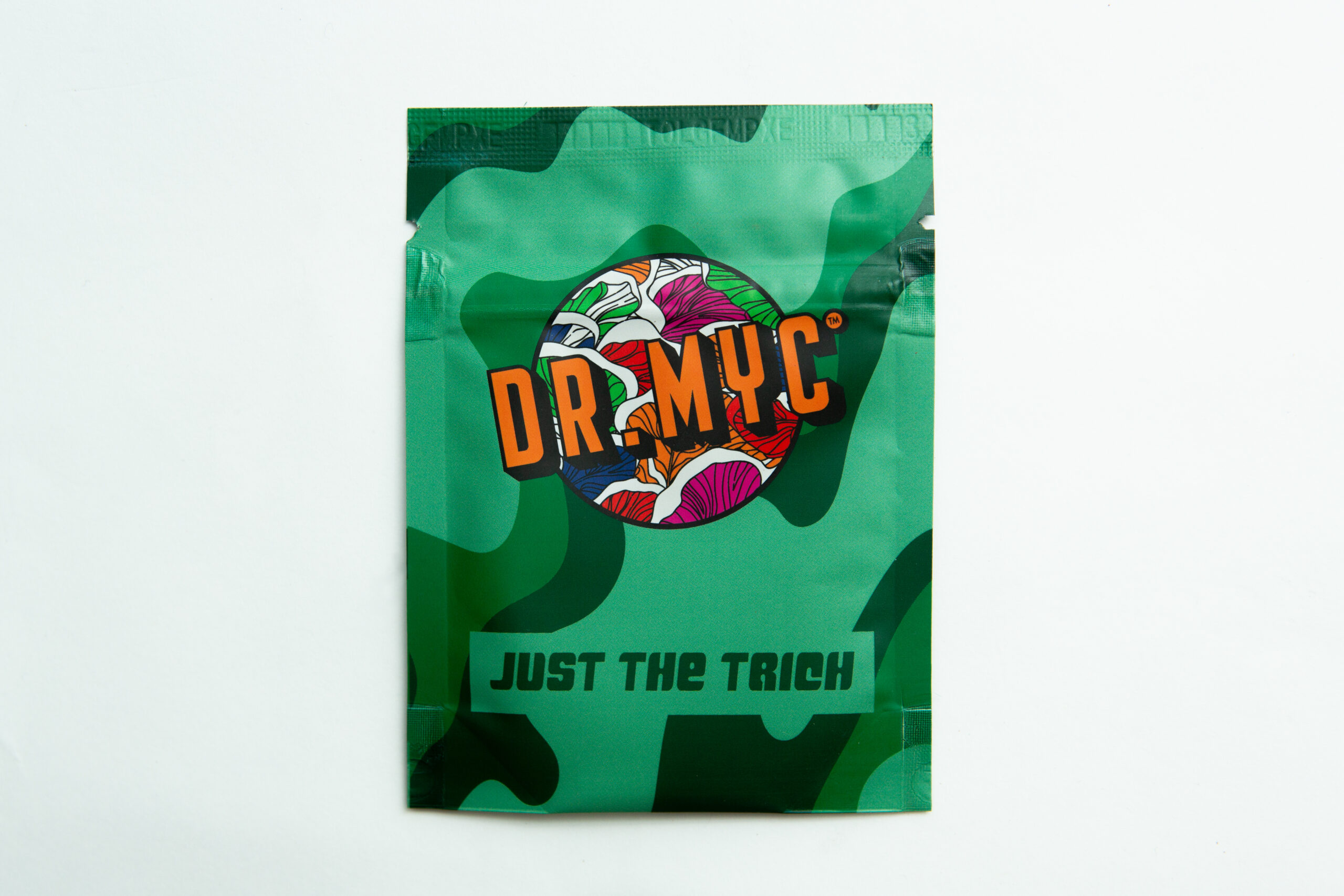 DRMyc Just-the-Trich - For Substrate Vitality 1 Green camo pouch labelled DR. MYC with colourful mushrooms and "JUST THE TRICH" at the bottom, featuring DRMyc Adaptive Liquid Culture Premix for your growing needs.