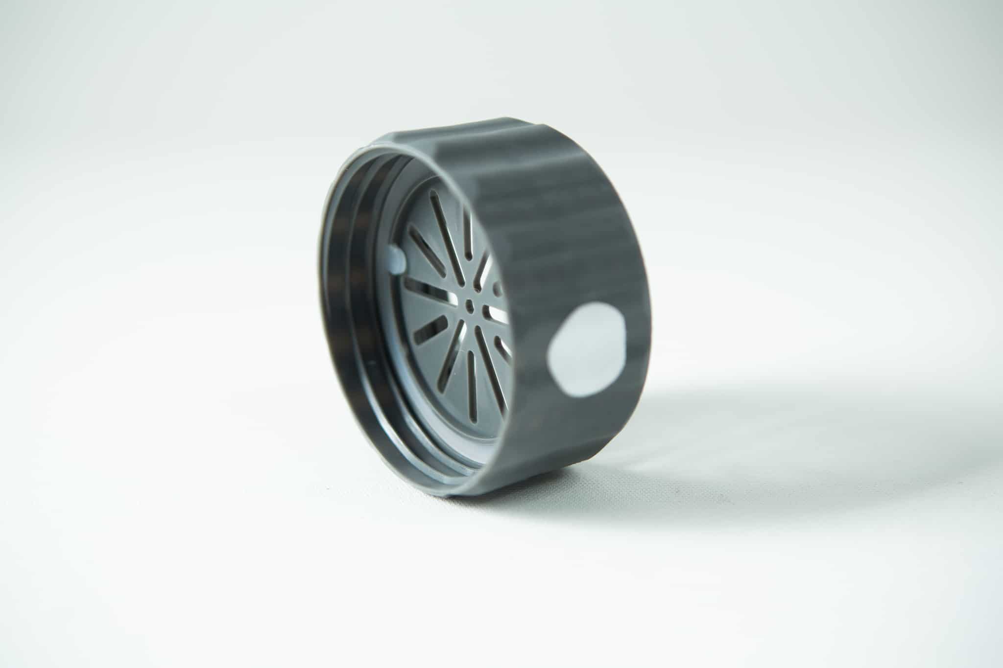 Plant Cell Biocoupler™ collar only (regular mouth) 6 A black plastic circular lid with a slotted inner pattern, from the Plant Cell Biocoupler™ Glass Set (16oz, 12oz, 8oz), is shown on a white surface.