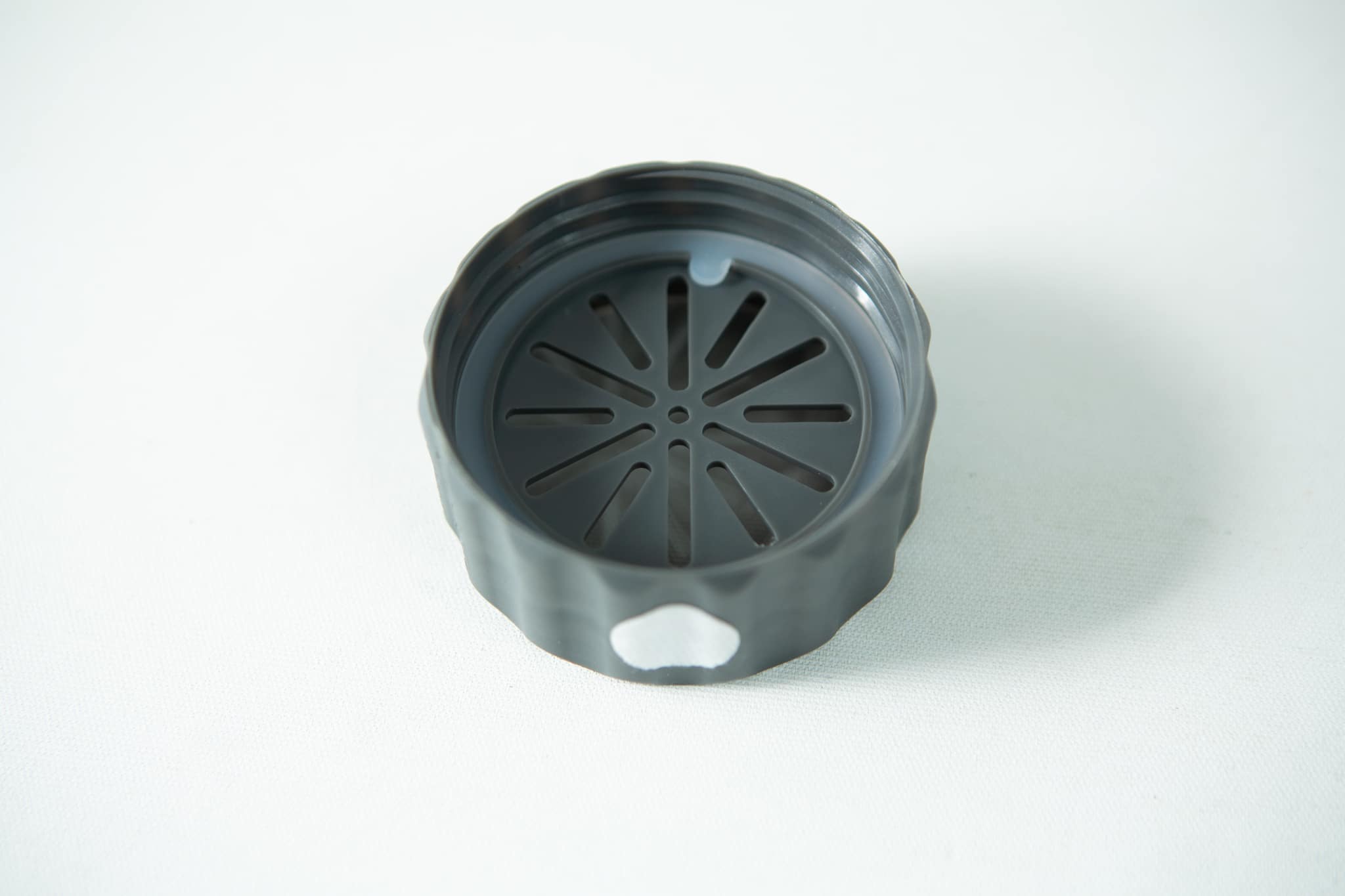 Plant Cell Biocoupler™ collar only (regular mouth) 3 A black, round plastic lid with a slotted vent pattern, designed for the Plant Cell Biocoupler™ Glass Set (16oz, 12oz, 8oz), is shown on a white surface.