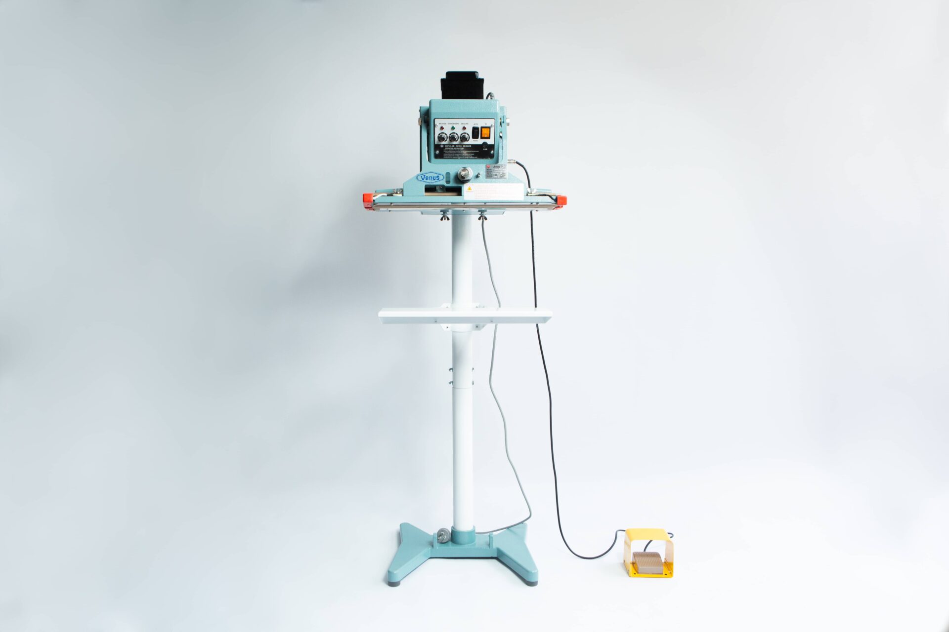 Vertical Foot Heat Sealer VHVD 450mm Double 10mm | Venus 1 The Vertical Foot Heat Sealer VHVD 450mm Double 10mm by Venus is a standing industrial machine with a control panel and yellow foot pedal, shown against a white background.