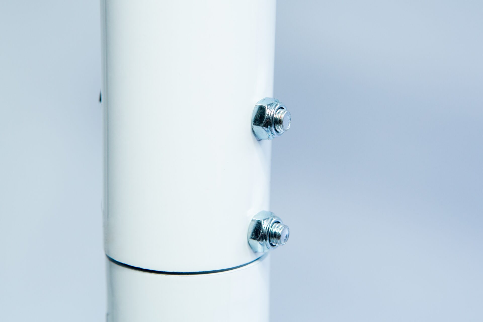 Vertical Foot Heat Sealer VHVD 450mm Double 10mm | Venus 9 Close-up of two metal bolts securing the Vertical Foot Heat Sealer VHVD 450mm Double 10mm | Venus, featuring a white cylindrical tube against a light background.