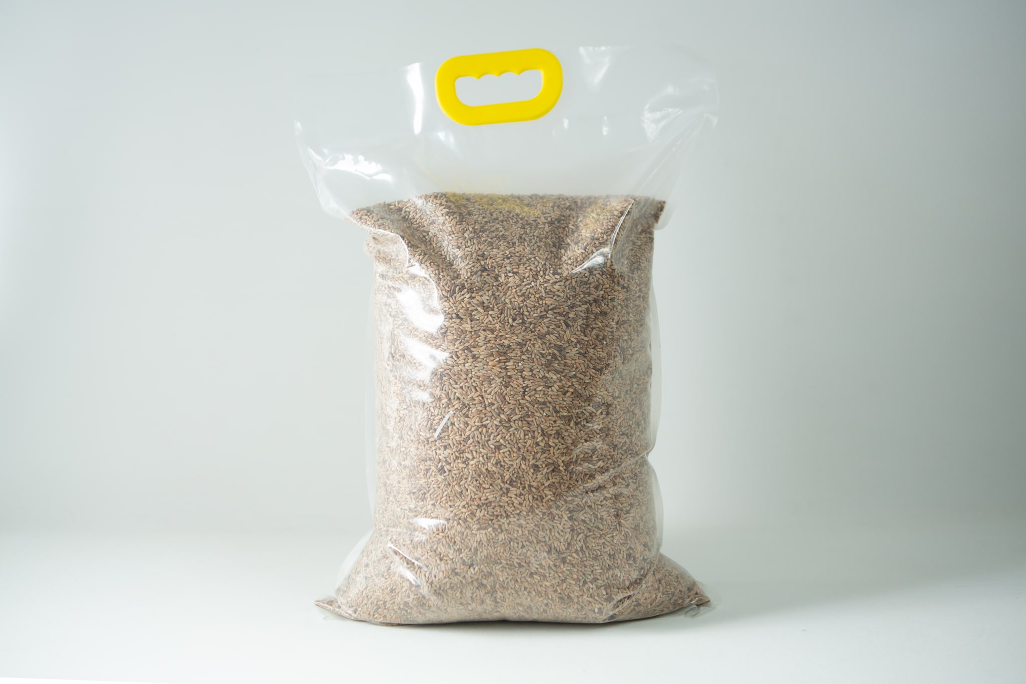 Certified Organic Biodynamic Rye berry grain 1 A sealed plastic bag of Certified Organic Biodynamic Rye berry grain, filled with brown grains and featuring a yellow handle at the top.