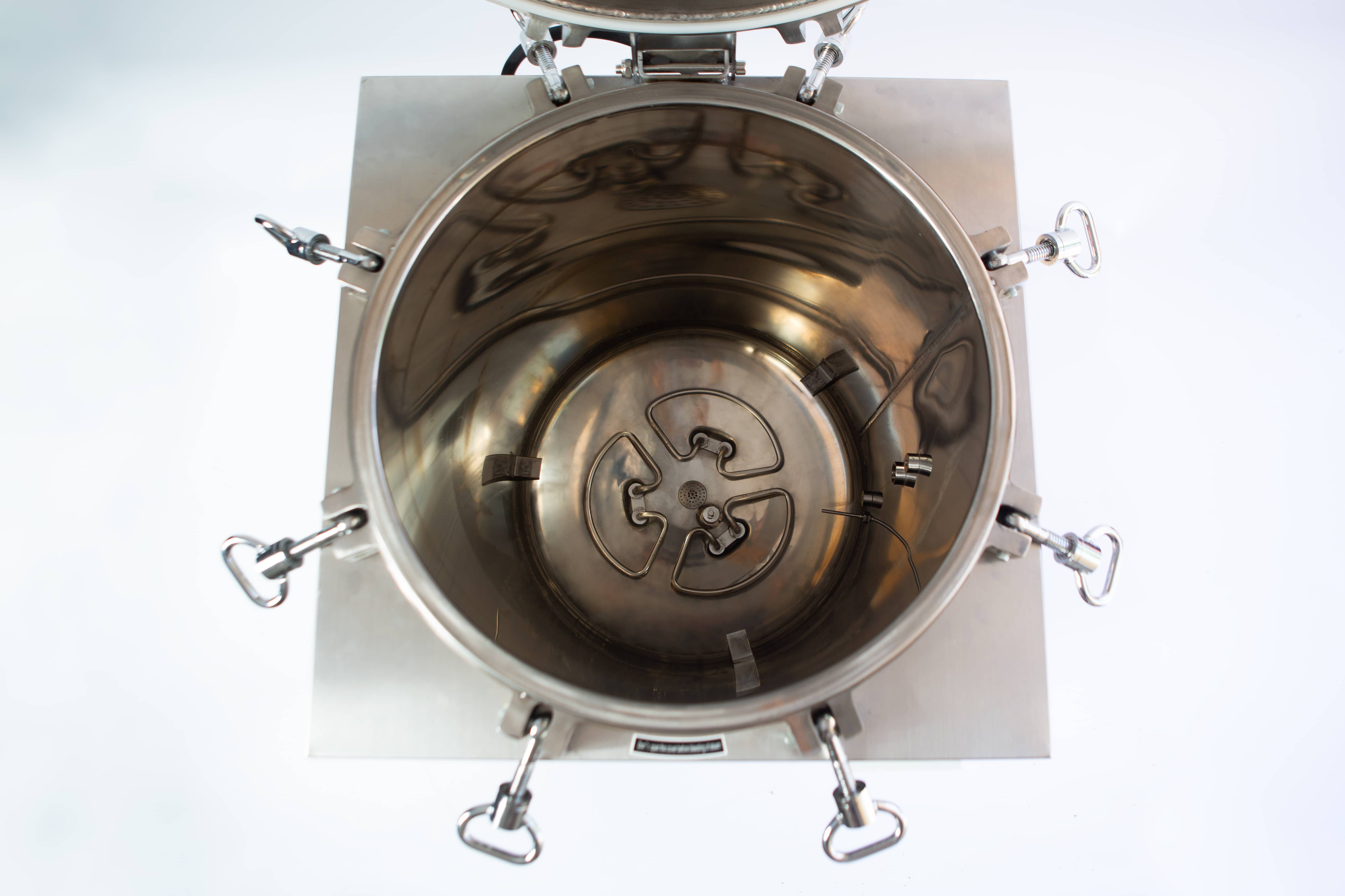 Vertical Autoclave 150 Liters (Automatic) | Commercial use | 6KW 8 Top-down view of an open stainless steel industrial mixing or processing vessel with clamps around the edge.