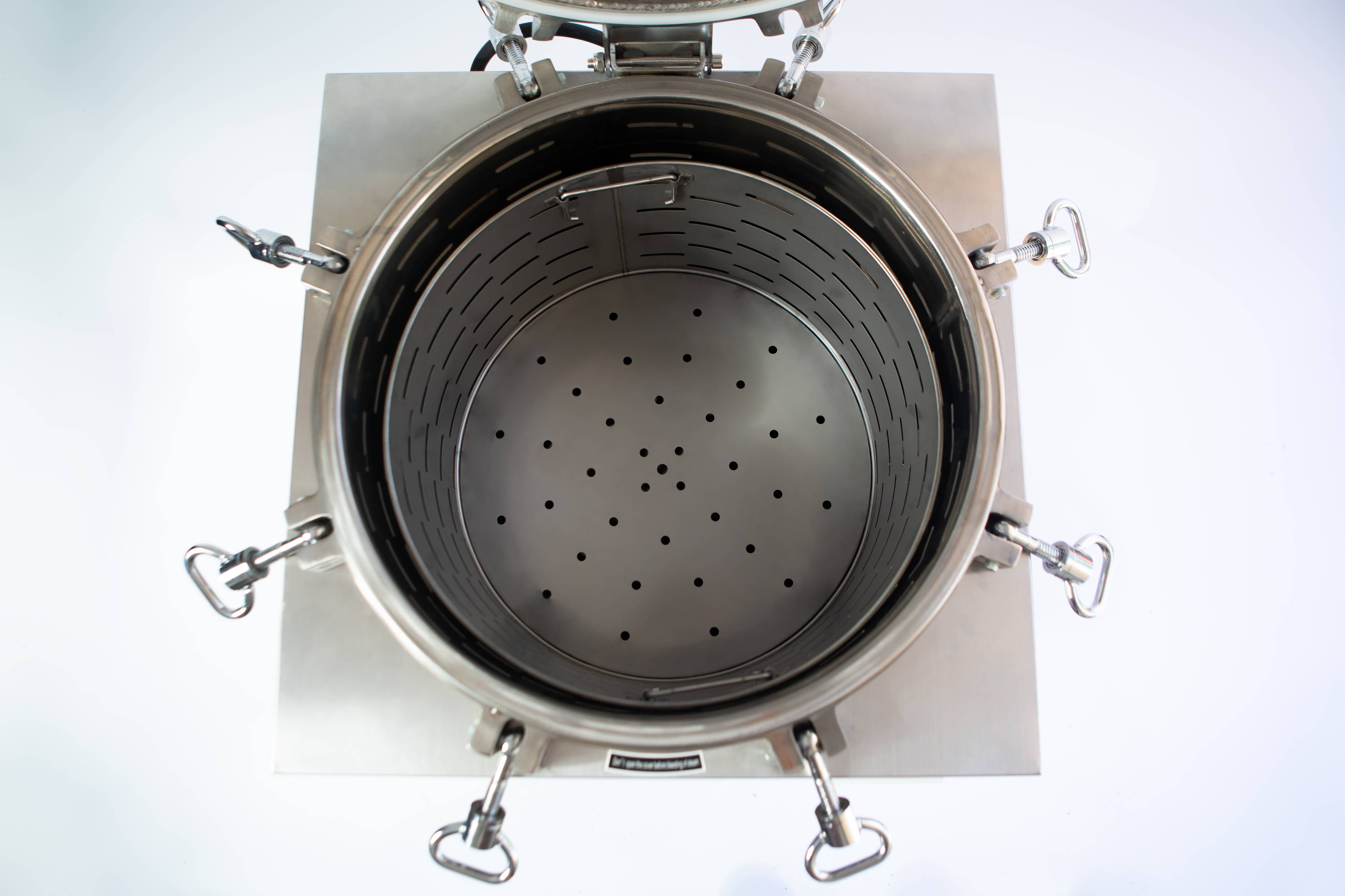 Vertical Autoclave 150 Liters (Automatic) | Commercial use | 6KW 10 Top view of an open stainless steel industrial container with a perforated plate inside.