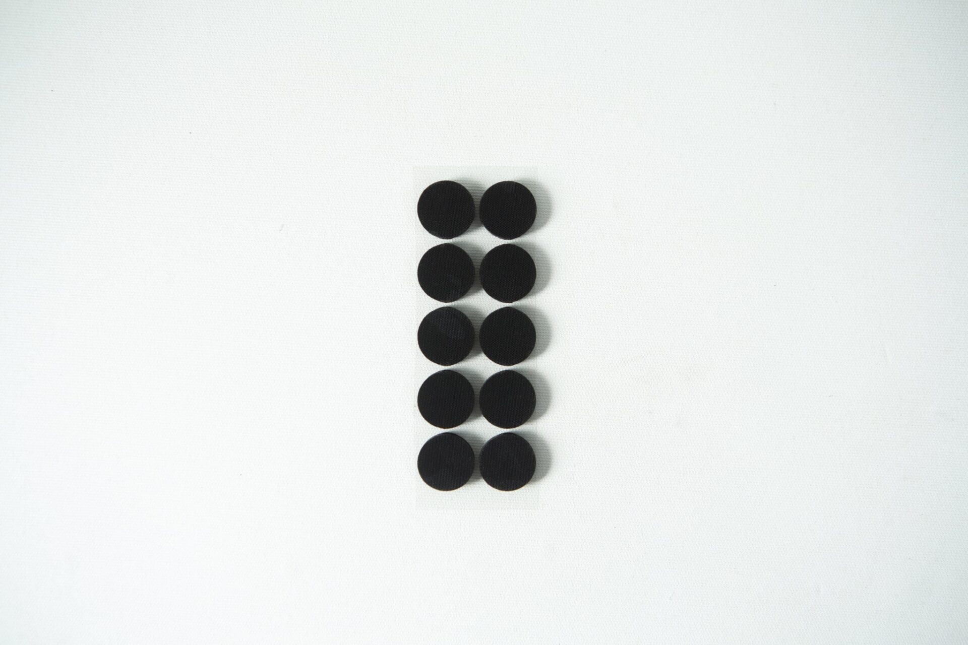 Self-healing injection port & Air Vent Filter-3M 12 Ten small black circular pads arranged in two columns on a white background.