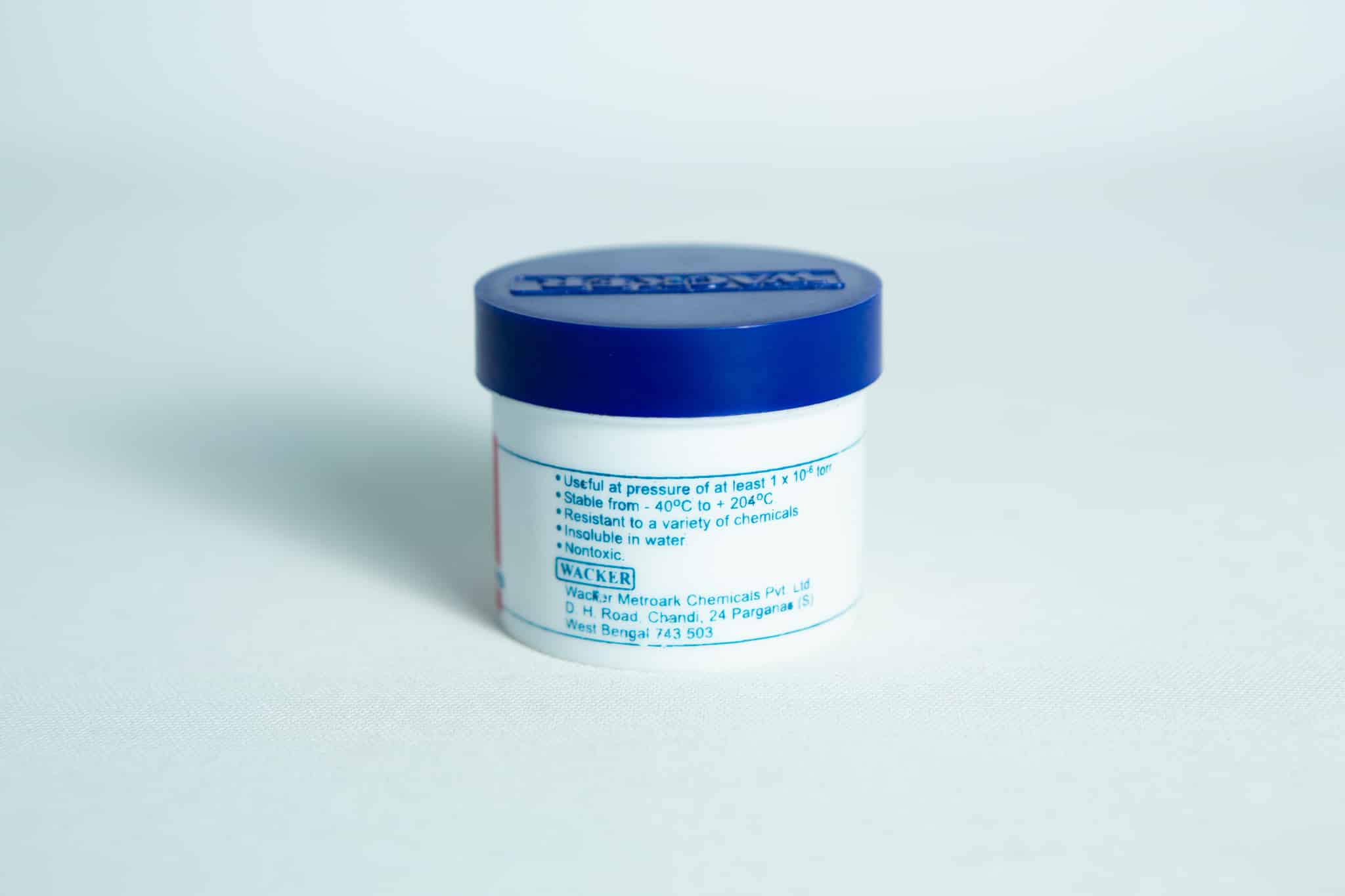 Silicone Grease Lubricant High Temp Vacuum - Metroark 2 Metroark Silicone Grease Lubricant High Temp Vacuum in a small white container with a blue lid and blue text, set against a plain light background.