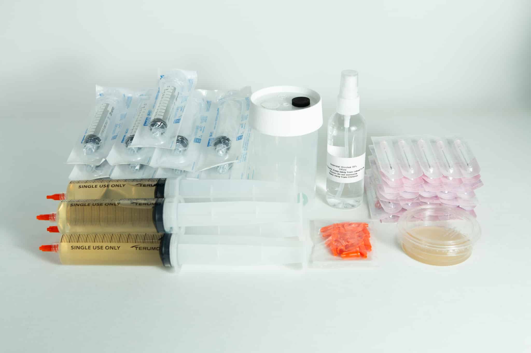 Liquid culture to Liquid culture expansion Kit 1 Liquid culture to Liquid Culture Expansion Kit with syringes, spray bottle, petri dish, and plastic containers displayed on a white background.