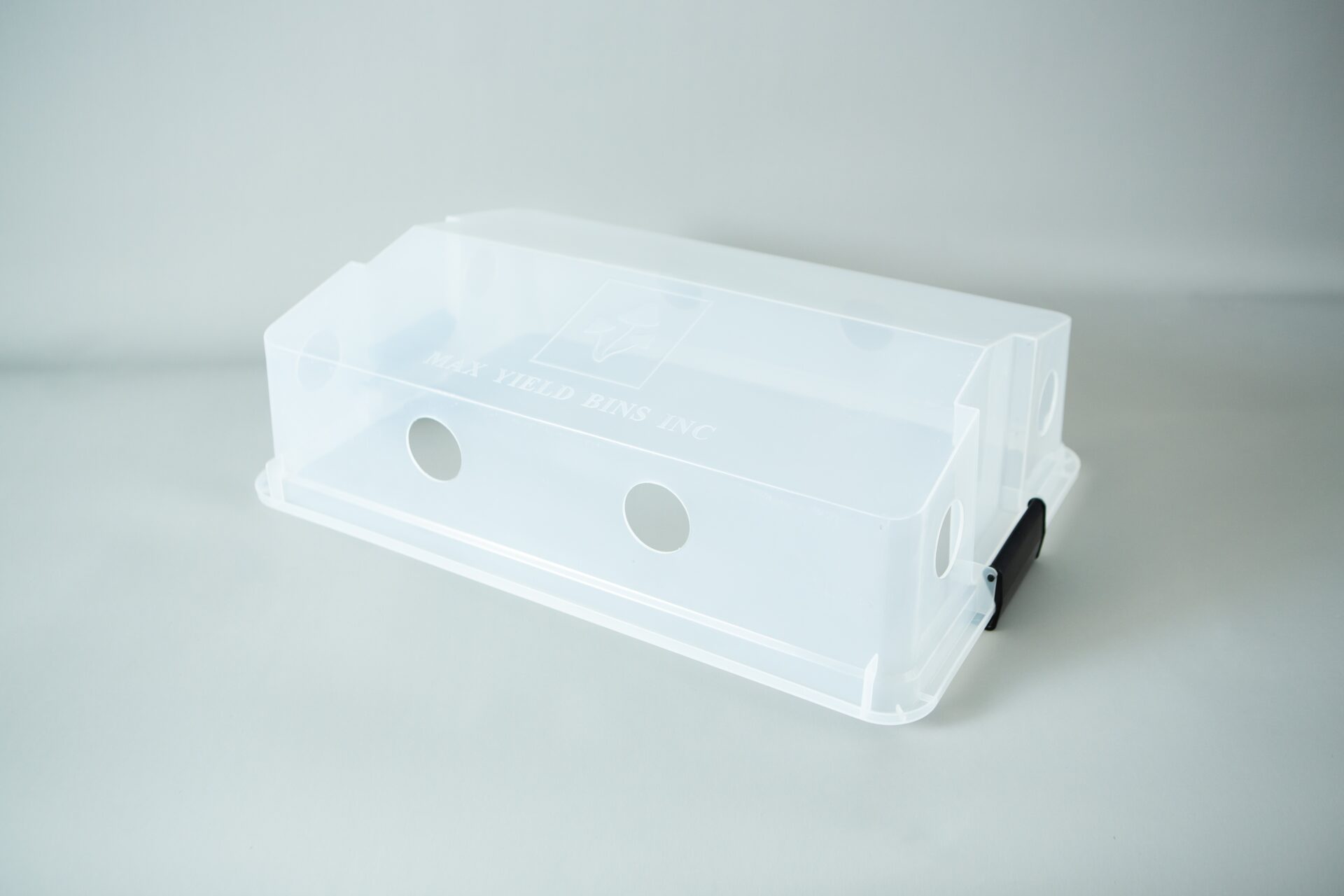 Monotub kit for Growing mushrooms- Max Yield Bins 3 Clear plastic box with circular holes and a black handle, perfect as a monotub kit for growing mushrooms, on a plain white background.