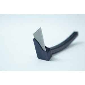 A close-up of the Mushroom Cutter, a utility razor blade in a black plastic holder on a white background, featuring a sleek design.