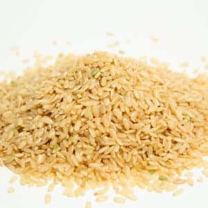 Brown Rice Grain is shown as a pile of uncooked grains on a white background.