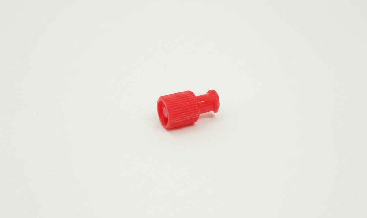 Sterile Syringe Cap for Standard Luer lock Syringe 1 Small red sterile syringe cap with a ridged grip, placed on a plain white background.