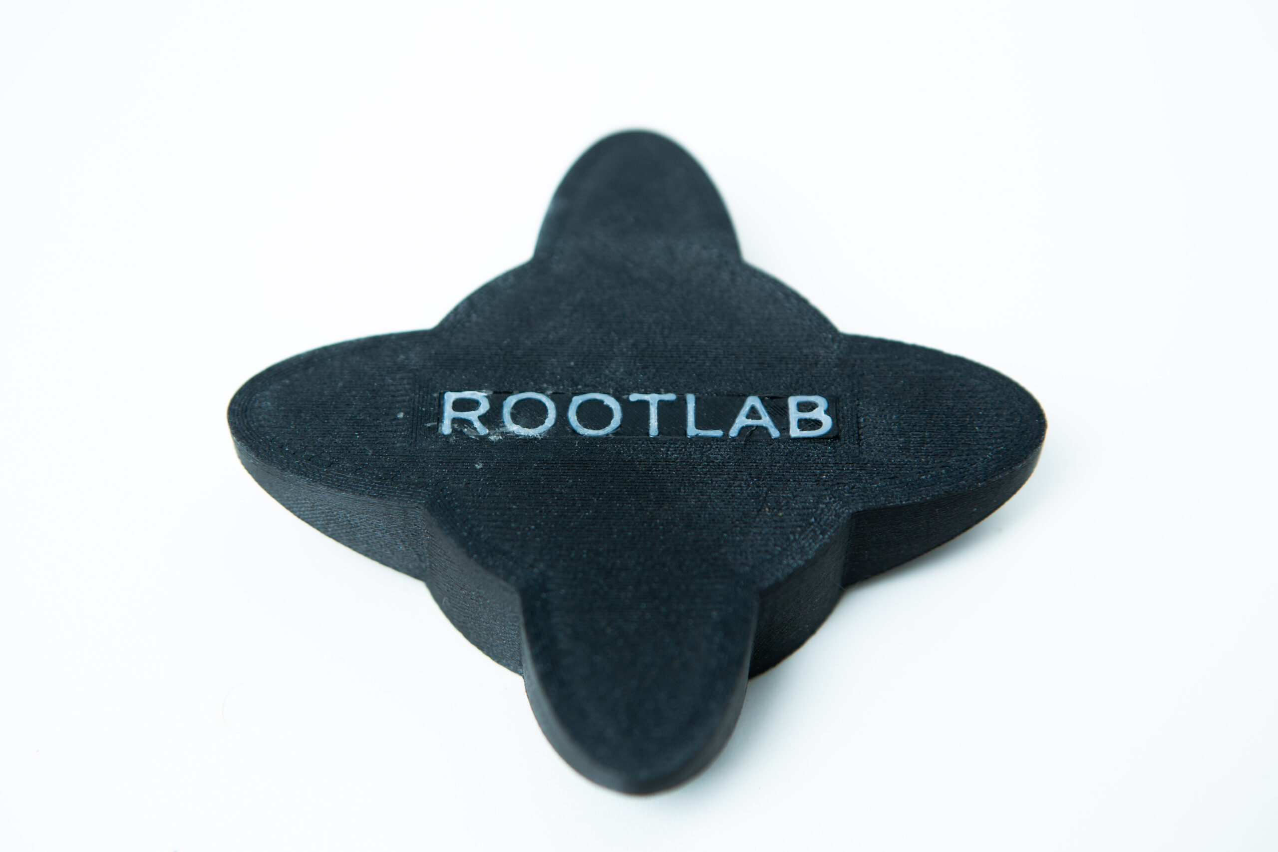 Reagent Bottle Cap Wrench | Rootlab Original | 3D Printed 1 A black, four-pointed object with ROOTLAB written on it, placed on a white background.