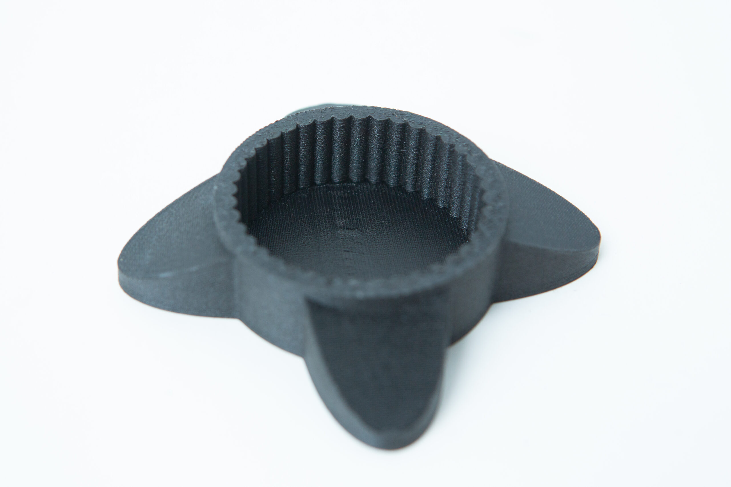 Reagent Bottle Cap Wrench | Rootlab Original | 3D Printed 3 A black, round, 3D-printed object with three flat, fin-like extensions on a white background.