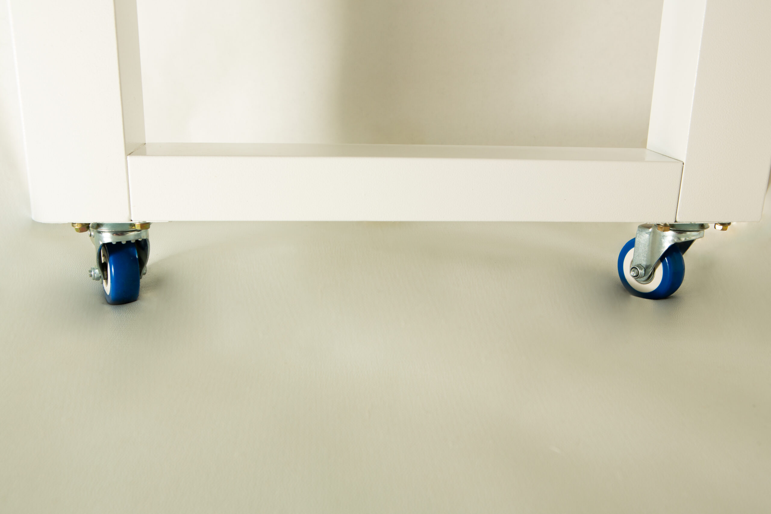 Horizontal Laminar Flowhood Cabinet | Clean bench 4 White metal frame with two blue castor wheels on a light-coloured floor.