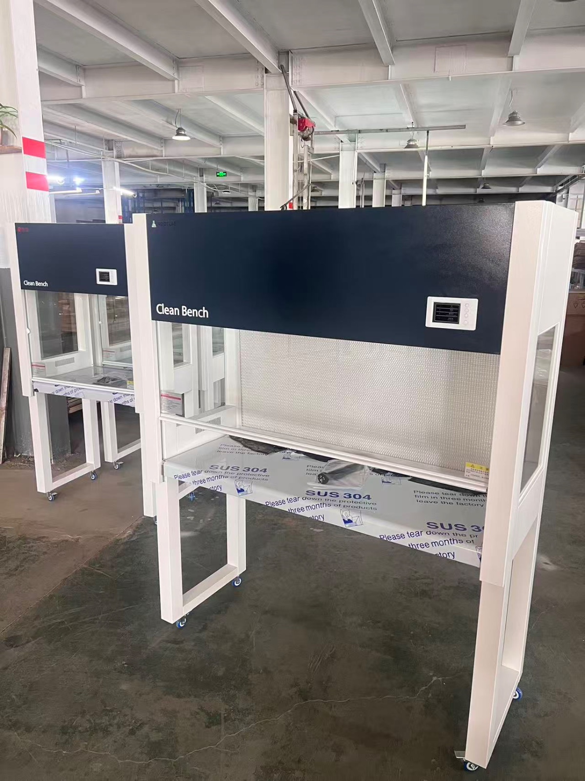 Horizontal Laminar Flowhood Cabinet | Clean bench 2 Two clean benches in a laboratory setting, with protective glass and HEPA filter visible.