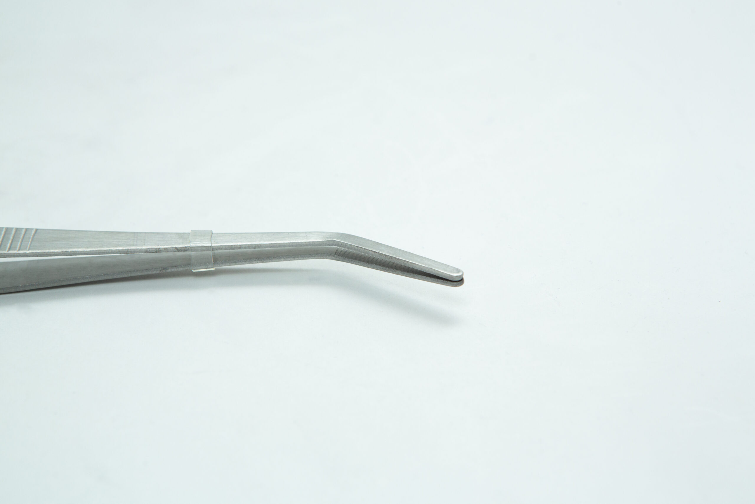 Stainless Steel Plant tissue culture Lab Forceps | Curved & Straight Tips | 25cm 3 A close-up of a metal tweezer with a curved tip against a plain white background.