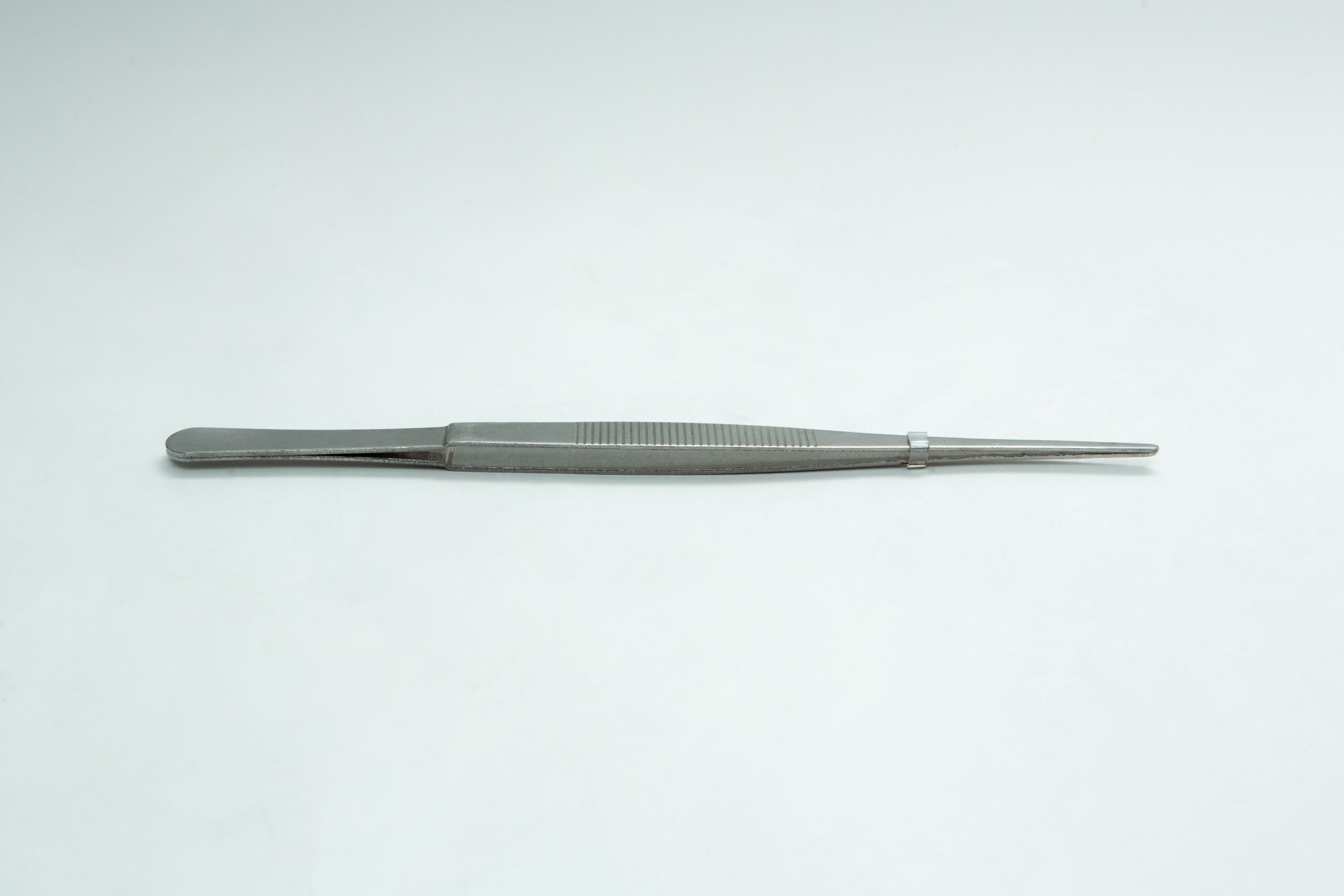 Stainless Steel Plant tissue culture Lab Forceps | Curved & Straight Tips | 25cm 6 A single metal pair of tweezers lies flat on a plain white surface.