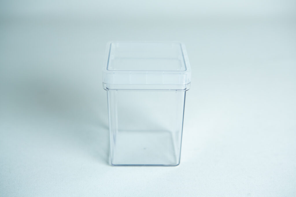 The Tissue Culture container, a clear empty rectangle with matching lid, is shown against a white background.