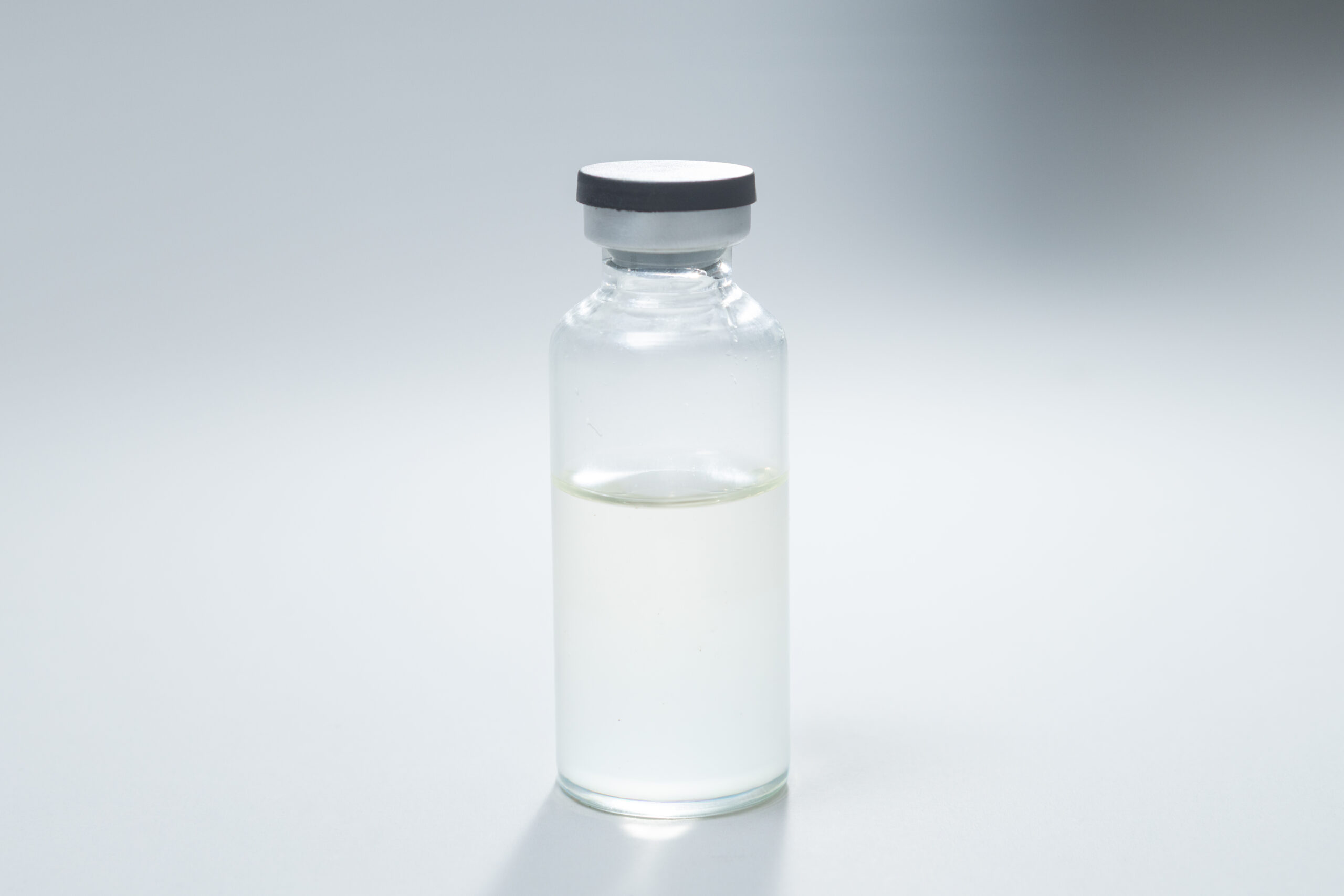 Sterile Liquid Culture Vials, Dr Myc Adaptive LC, Crimp Sealed 1 Sterile Liquid Culture Vials, Dr Myc Adaptive LC, 30 ml—crimp sealed with a grey cap and partially filled with transparent liquid in a clear vial on a plain white background—ideal for Adaptive LC applications with no pressure cooker needed.