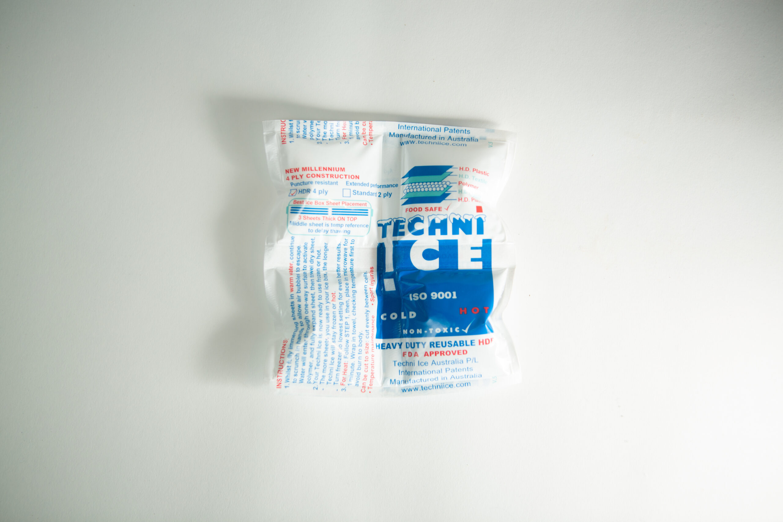 Ice Pack 2 A sealed Techni Ice pack with blue and red text on a white background, placed on a white surface.